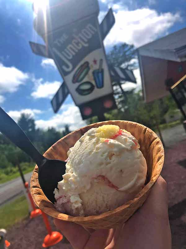 ice cream bowl in front of shop sign