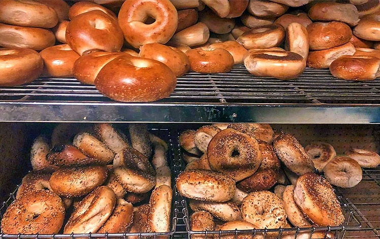 The Bagel Experience racks of bagels