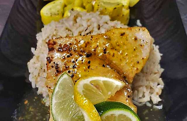 serving of margarita swordfish with lemons and limes