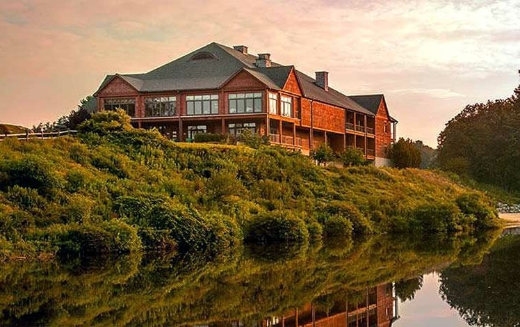 the inn at skytop lodge exterior of building on hill overlooking lake