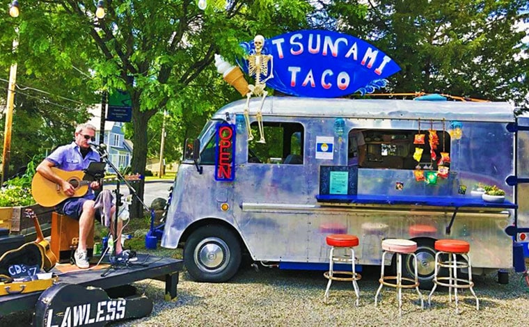 Tsunami Taco Truck with musician performing next to it