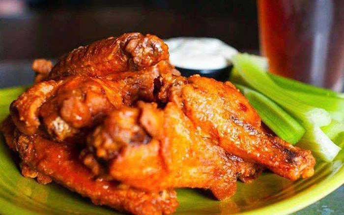 plate of chicken wings and beer