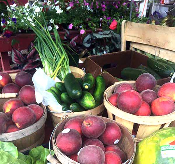 village-farmer-and-bakery-peaches-watermelon-lettuce-in-market