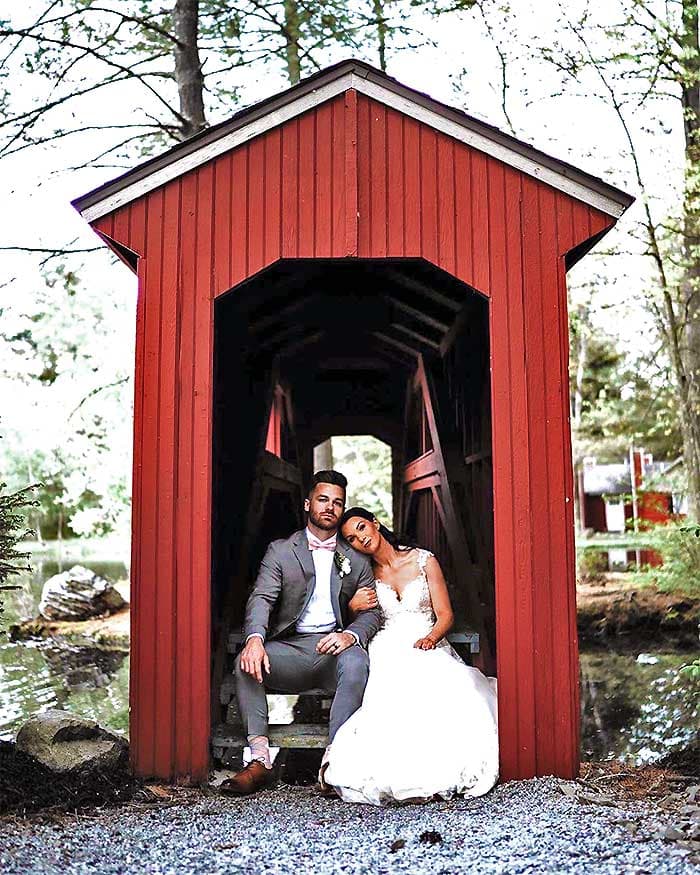 your memorytown wedding couple posing inside covered bridge